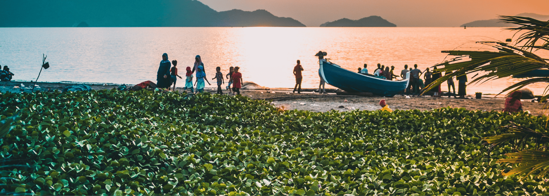 busy people by the small fishing boat in the shore